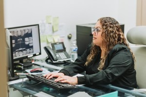 Female staff on the receiving area, with keyboard and computer monitor